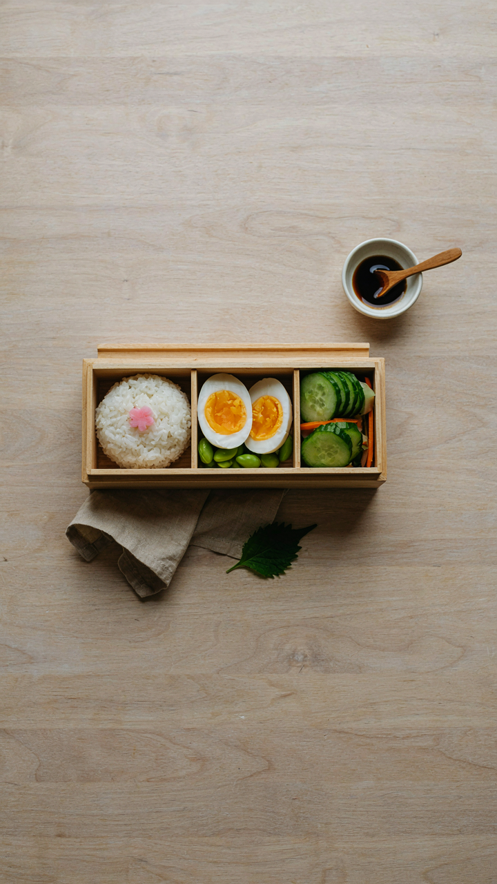 A bento box holds three identical portions of healthy food.